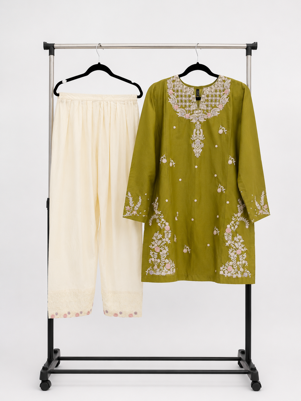 BACTRA olive embroidered kurta and ivory trousers displayed together on a rack