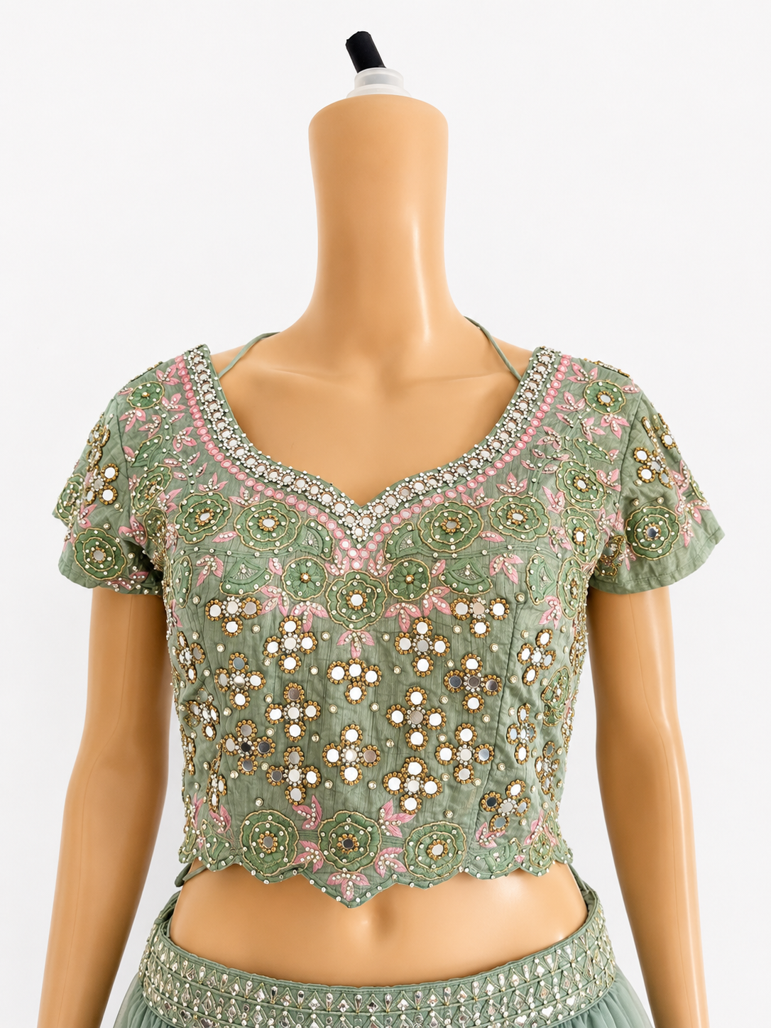 Front close-up of sage green embroidered mirrorwork blouse