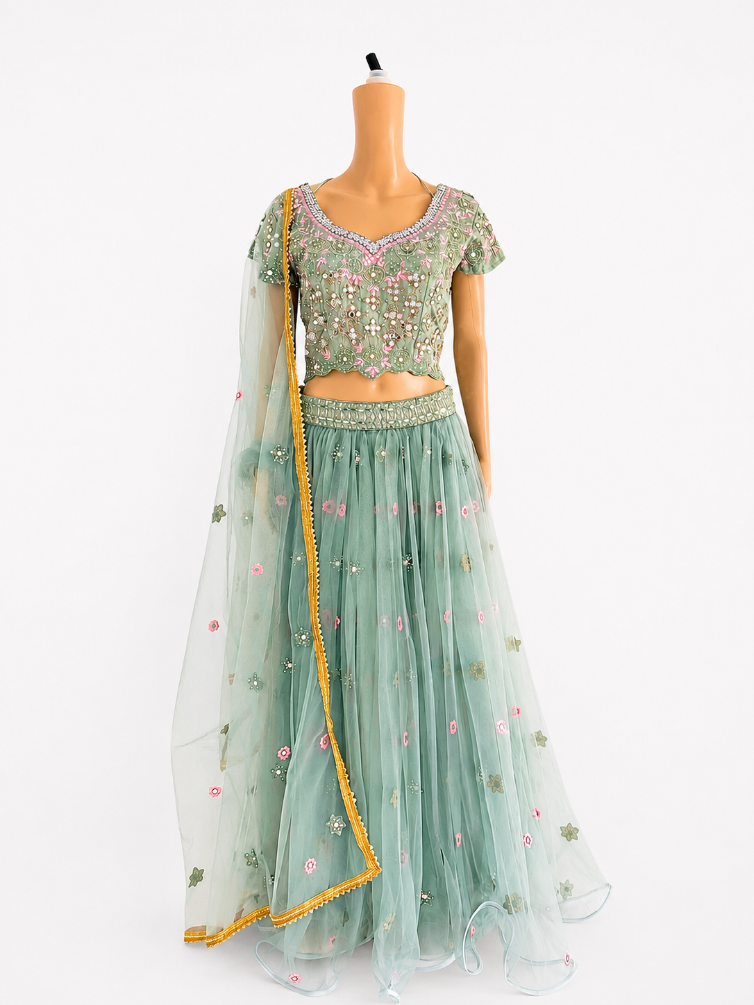 Front view of BACTRA sage green embroidered lehenga set on mannequin